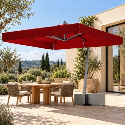 ombrellone a braccio Venere ambientato in una terrazza mediterranea, con tavolo in legno, sedute intrecciate e vegetazione.